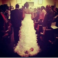 Woman Straps Baby to back of Wedding Gown